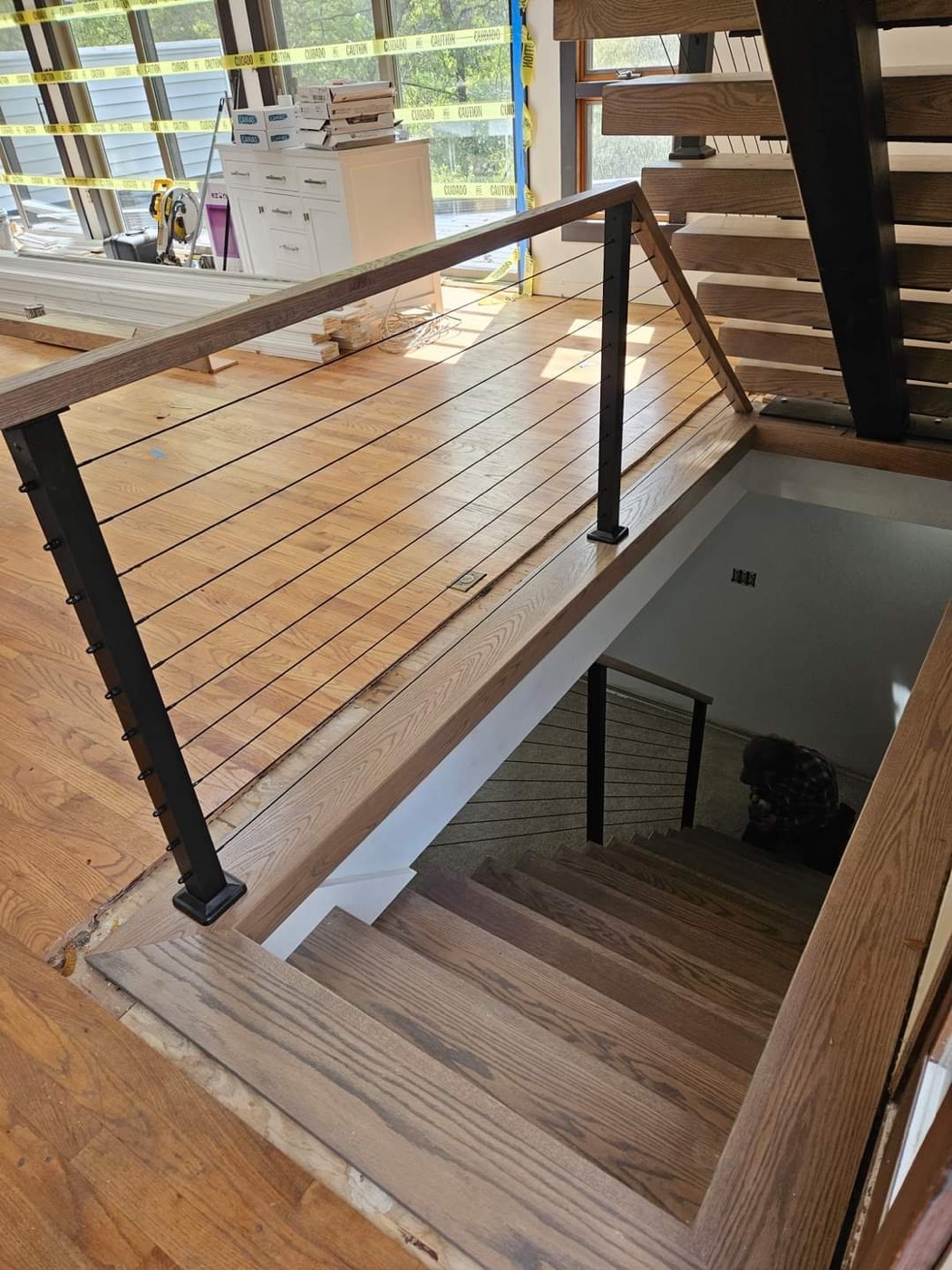 Cable railing detail with wood rail and black posts