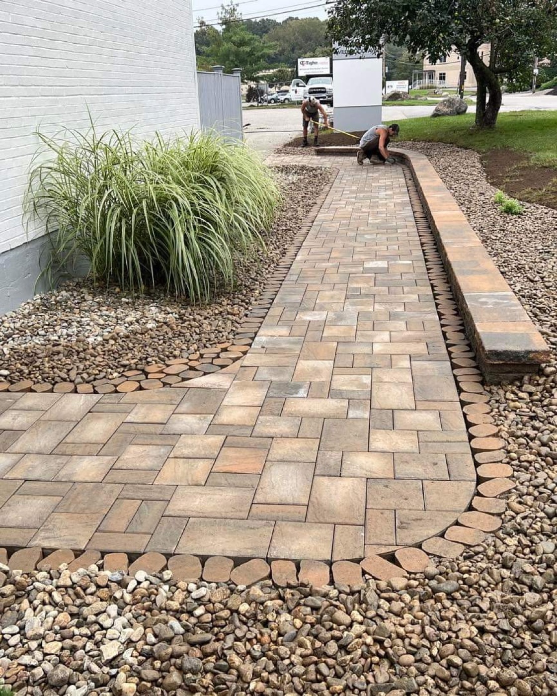 Long commercial-style paver walkway with border edging