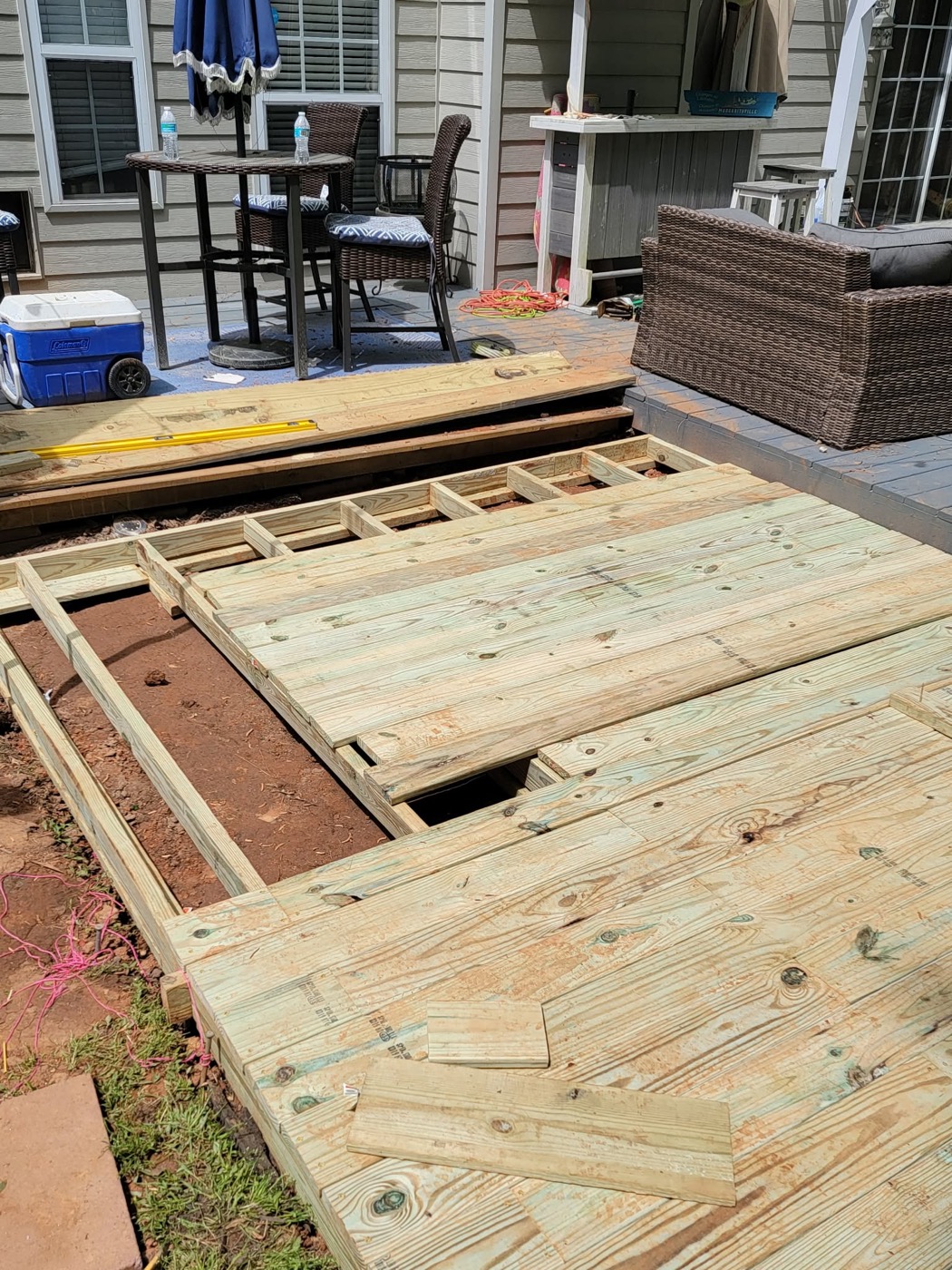 Deck build progress with framing and boards