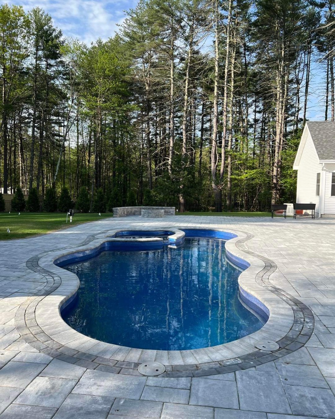 Finished pool paver deck with curved coping