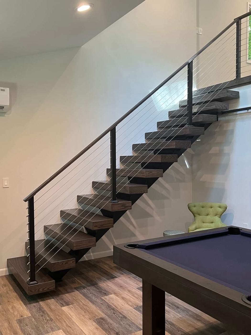 Dark floating stairs with cable railing