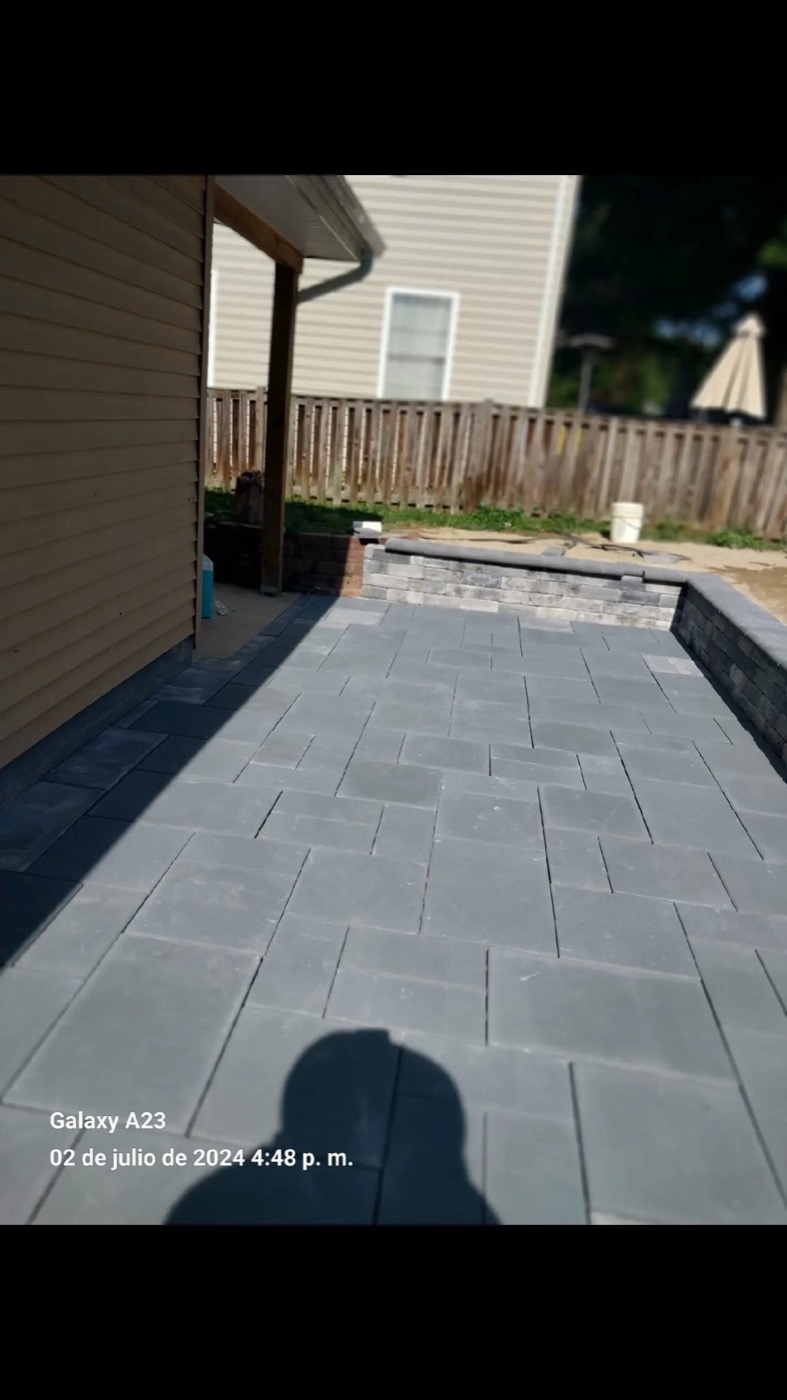 Gray paver patio with low stone wall