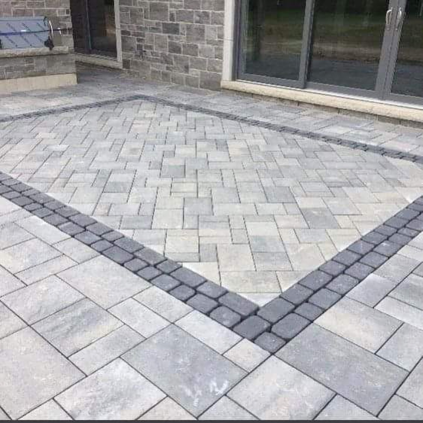 Paver patio with dark soldier-course border detail