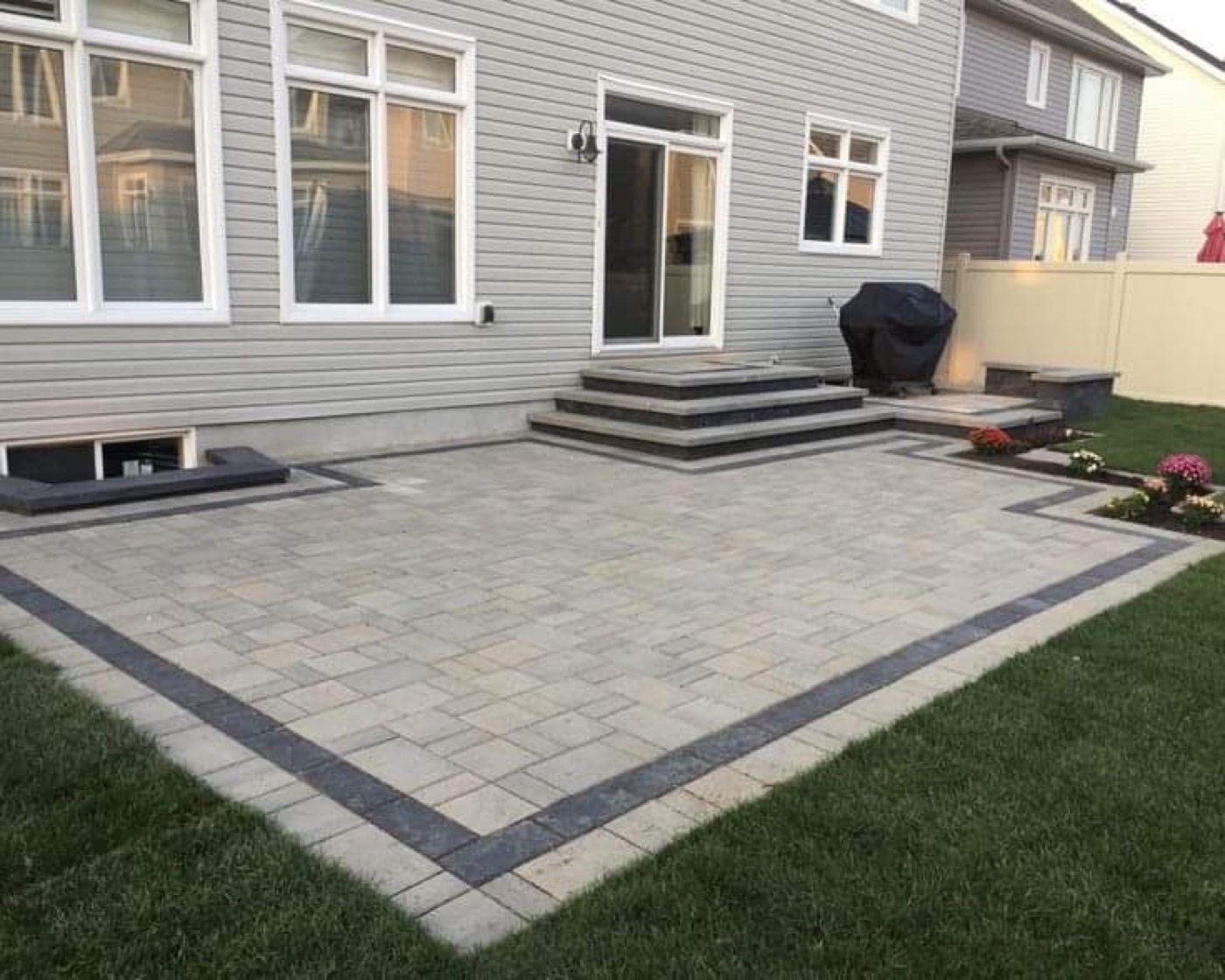 Raised paver patio with stone steps