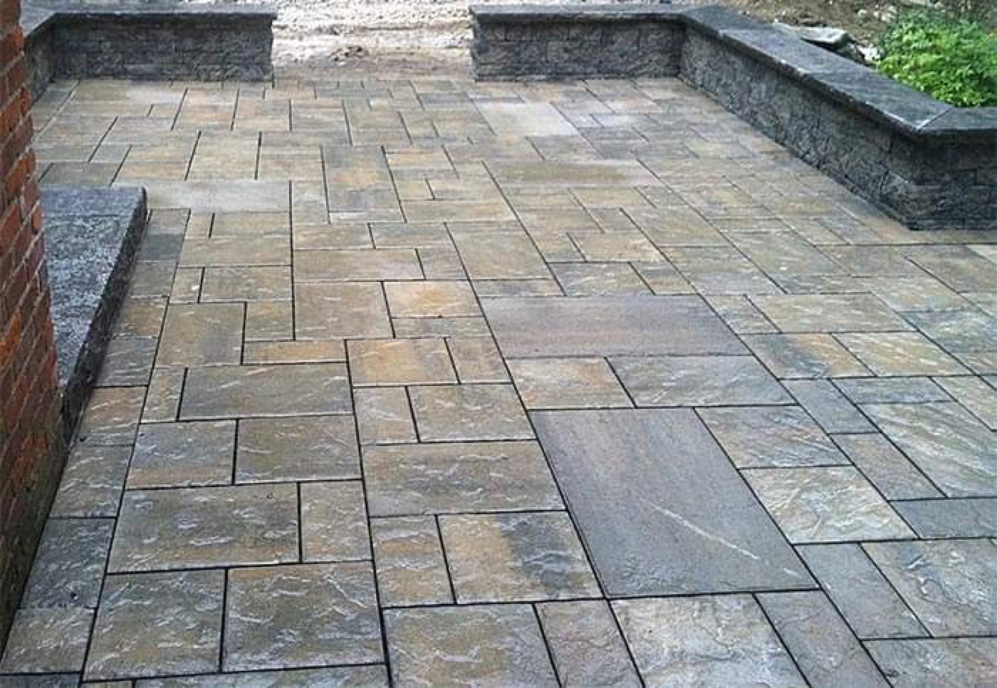 Wet-look stone patio with seat-wall edges